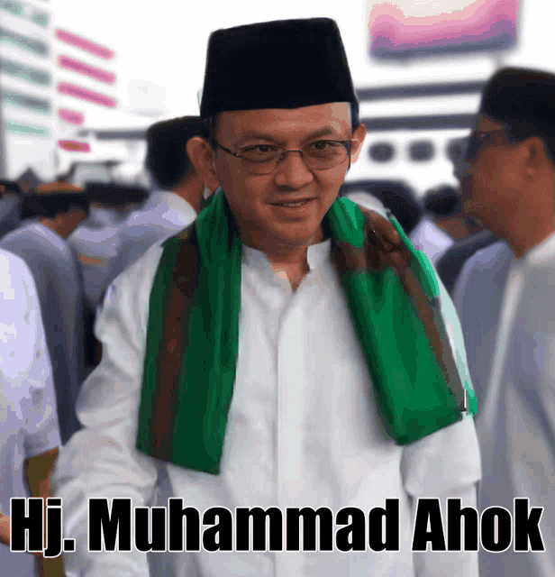 a man with a green scarf around his neck has the name hj muhammad ahok on the bottom