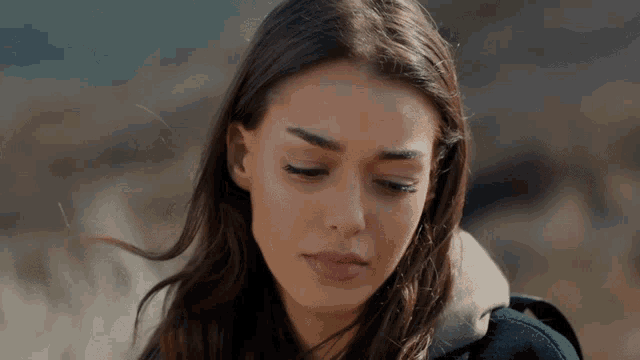a close up of a woman 's face looking down