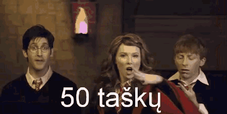 a group of people are standing in front of a sign that says 50 tasky on it