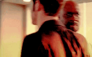 a blurry picture of two men hugging each other