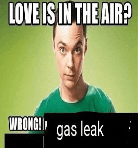 a man in a green shirt is holding a sign that says `` love is in the air ? wrong ! ''