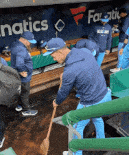 a group of baseball players are standing in a dugout with a sign that says fanatics