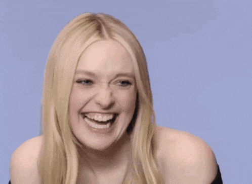 a woman with long blonde hair is laughing and making a funny face .