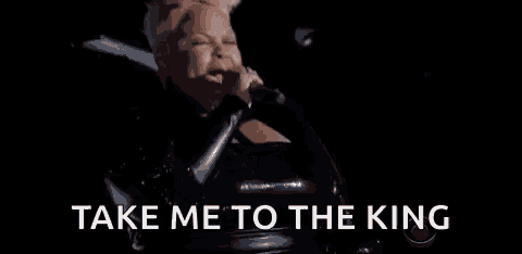 a woman is singing into a microphone with the words `` take me to the king '' written below her .