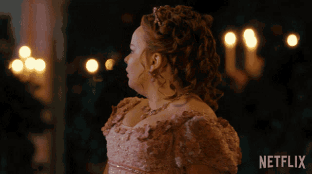 a woman in a pink dress with a netflix logo on the bottom