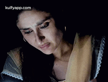 a close up of a woman 's face with her eyes closed .