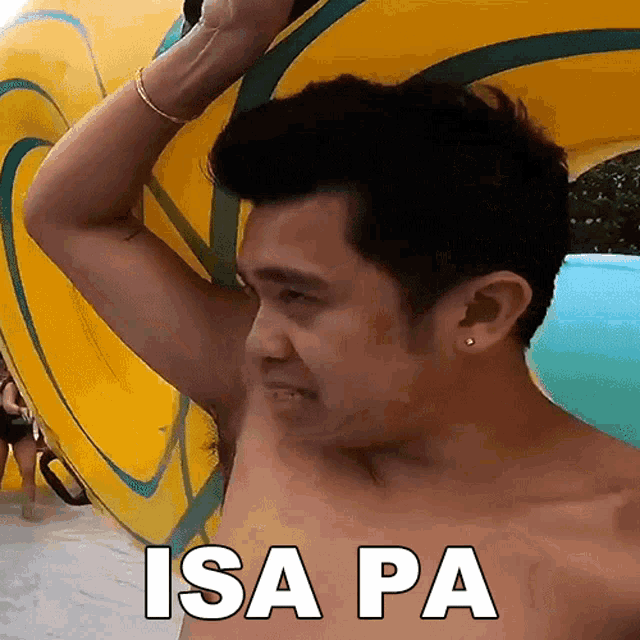 a shirtless man is holding a yellow float with the words isa pa on it