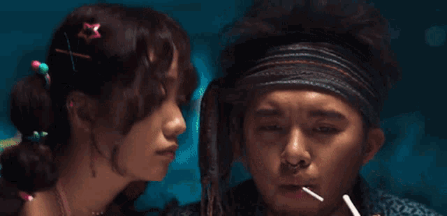 a woman with a star in her hair is kissing a man