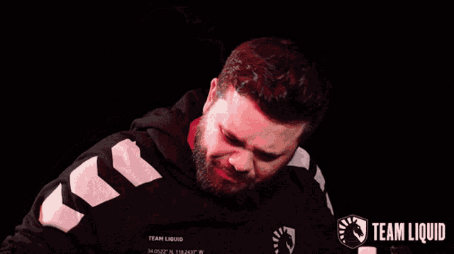 a man with a beard wearing a team liquid hoodie