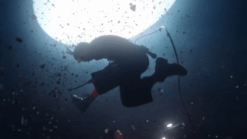 a man is singing into a microphone while swimming in the water