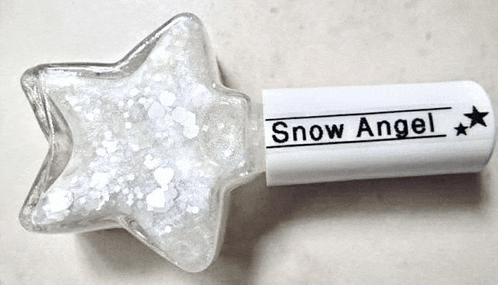 a bottle of snow angel nail polish is shaped like a star