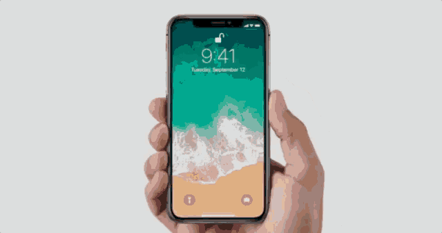 a hand is holding a cell phone with a green and brown background