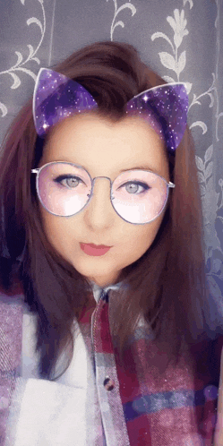 a girl wearing glasses with purple cat ears