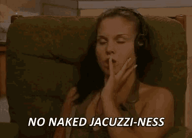 a naked woman is sitting in a chair wearing headphones and saying no naked jacuzzi-ness .