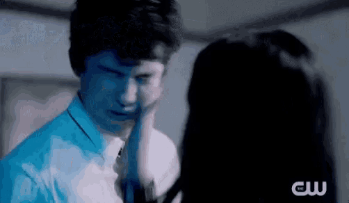 a man and woman are standing next to each other in a dark room .