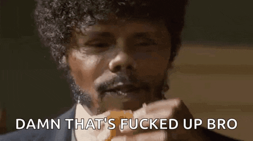 a man with curly hair is eating a sandwich and saying damn that 's fucked up bro