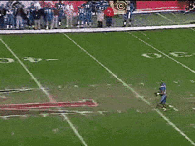 a football game is being played on a field with the letter g on the sideline