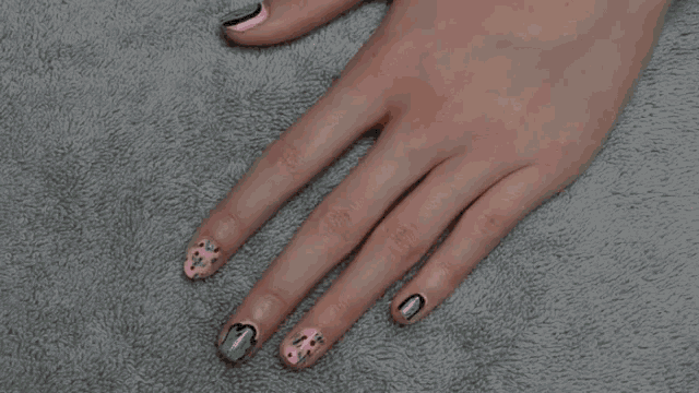 a person 's feet are laying on a gray carpet .