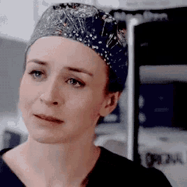 a close up of a woman wearing a scrub cap and a black shirt