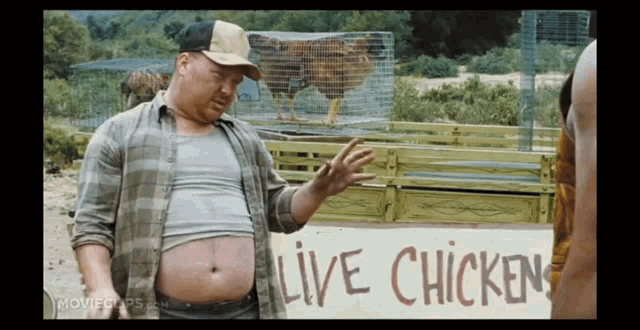 a man is standing in front of a sign that says live chicken