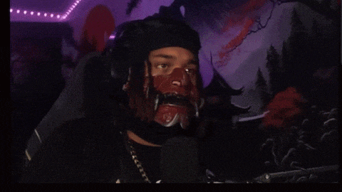 a man wearing a mask and headphones is looking at the camera