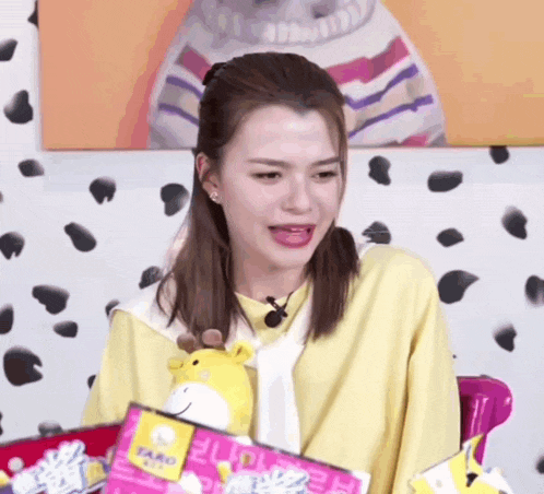 a woman is holding a stuffed animal in front of a dalmatian wall ..