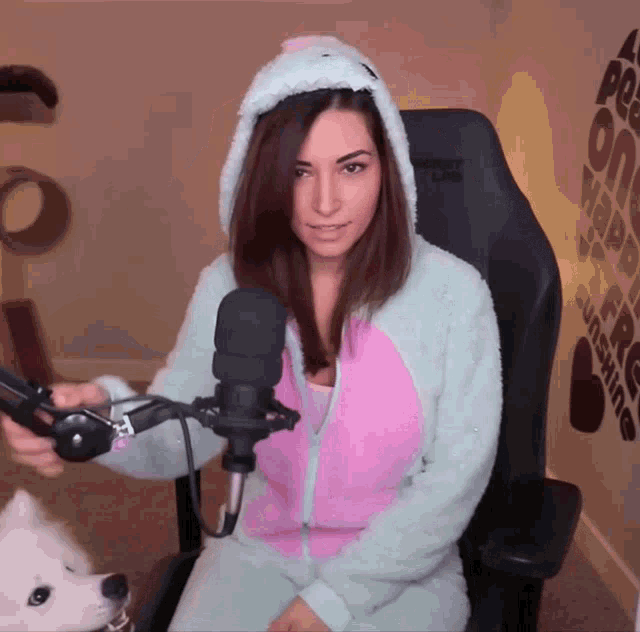 a woman sitting in a chair with a microphone in front of a chair that says monkey link