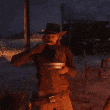 a man wearing a cowboy hat is holding a plate in his hand