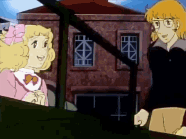 a boy and a girl are talking in front of a building