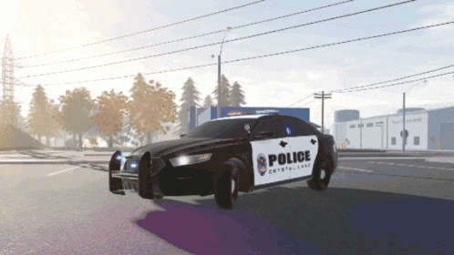 a black and white police car is driving down the street