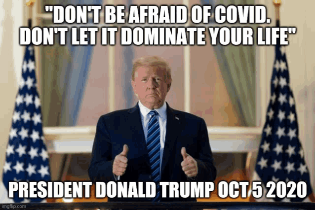 president donald trump giving a thumbs up in front of the american flags