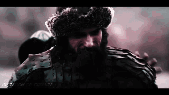 a man with a beard wearing a fur hat
