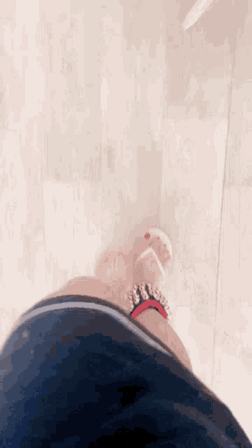 a woman 's feet wearing a pair of flip flops with spikes on them .