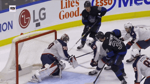 a hockey game is being played in front of an lg banner