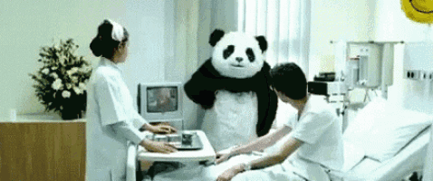 a panda bear is in a hospital room with a nurse and a patient