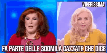 two women are sitting next to each other and one of them is wearing a yellow dress