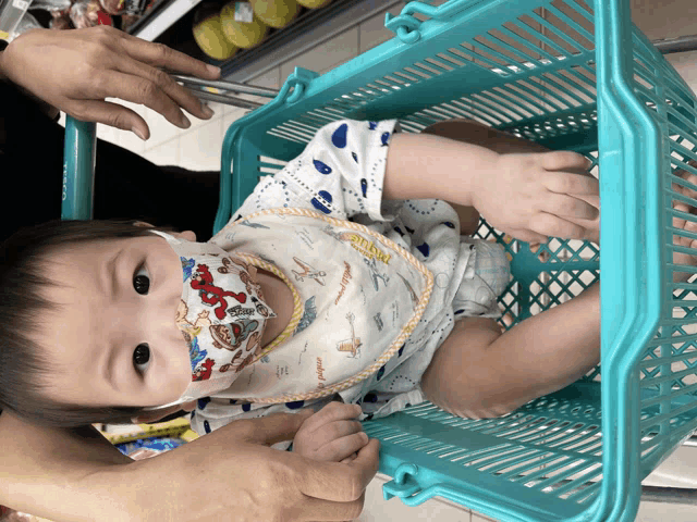 a baby wearing a bib that says ' winnie the pooh ' on it