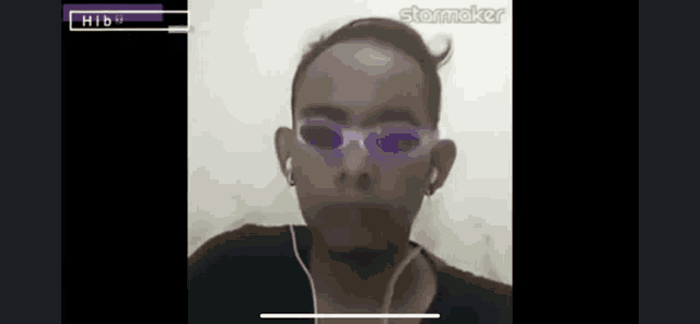a man wearing a pair of purple sunglasses and earbuds
