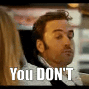 a man is sitting in a car with a woman and the words `` you don 't '' written on his face .