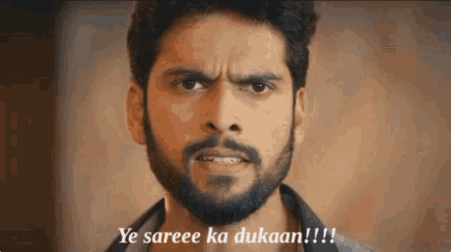 a man with a beard is making a funny face and says ye saree ka dukaan !!!