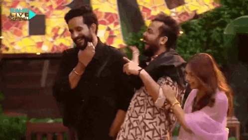 a group of people are standing next to each other in front of a sign that says live channel .