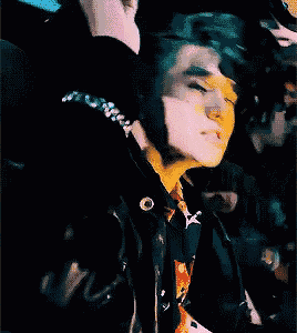 a close up of a person wearing sunglasses and a black jacket
