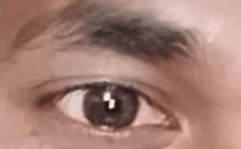 a close up of a person 's eye with a reflection of a lightning bolt .
