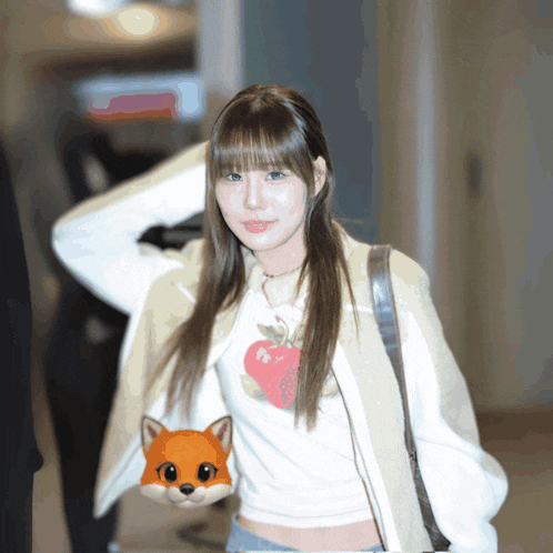 a woman wearing a white sweater with a heart on it