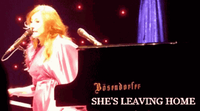 a woman singing into a microphone while playing a piano that says bosendorfer