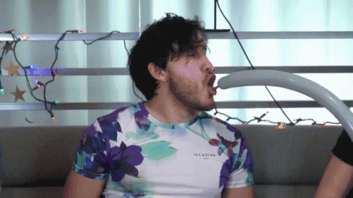 a man wearing a floral shirt that says illusive on it