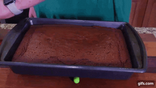 a piece of chocolate cake is in a pan on a table .