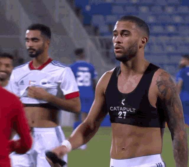 a shirtless soccer player wearing a catapult 27 chest monitor