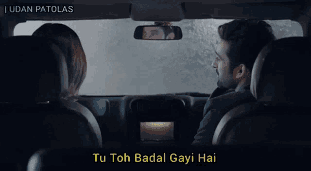 a man and a woman are sitting in a car with the caption tu toh badal gayi hai