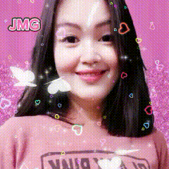 a woman wearing a pink shirt with the word vans on it is smiling